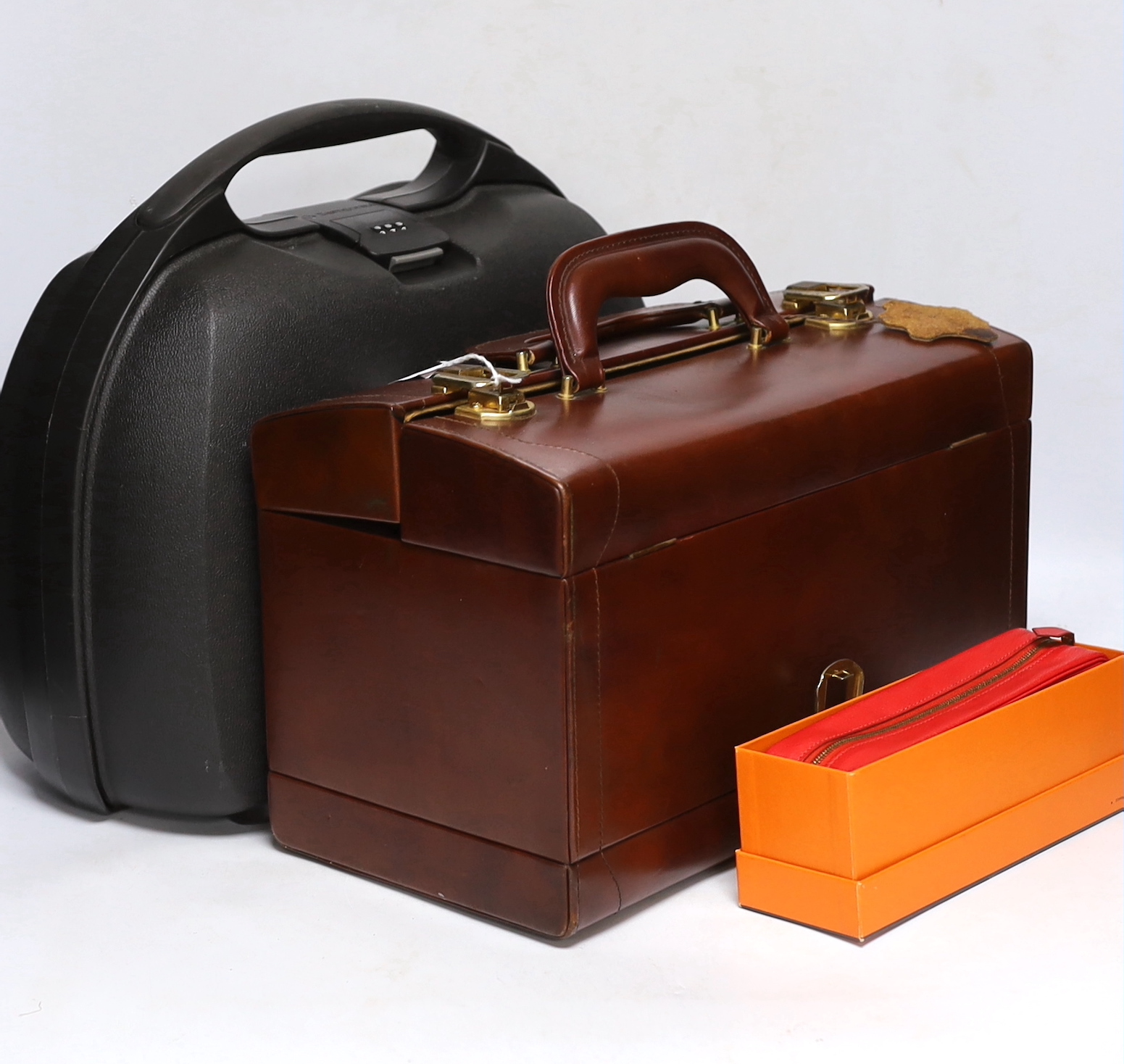 Hermes boxed red leather pen case, a Samsonite black hard plastic overnight case and a brown leather vanity/jewllery case, largest 34cm high
